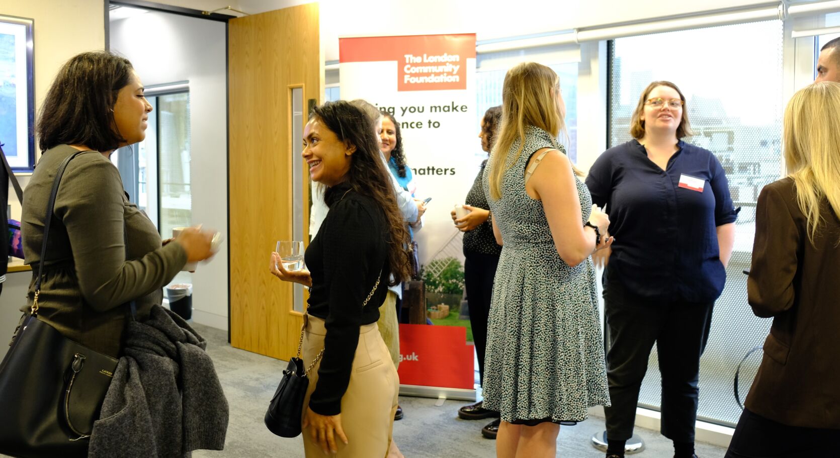 A group of people talking together over refreshments at the Women's Fund for London event